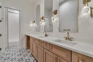 Full bath with double vanity and shower / bath combo