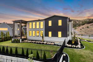 Back of house with a fenced backyard