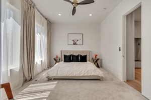 Carpeted bedroom with recessed lighting and a ceiling fan