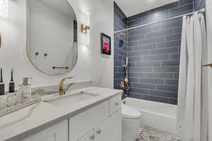 Bathroom with shower / tub combo and vanity