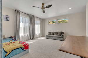 Carpeted bedroom featuring multiple windows, a ceiling fan, and recessed lighting