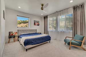 Carpeted bedroom with recessed lighting and ceiling fan