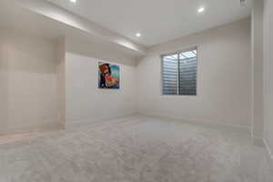 Basement with light carpet and recessed lighting
