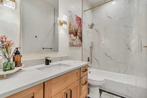 Full bathroom with tub / shower combination and vanity