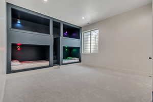 Unfurnished bedroom with carpet flooring and recessed lighting