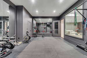 Exercise area featuring baseboards and recessed lighting
