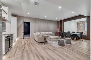Living room with recessed lighting and light wood-type flooring