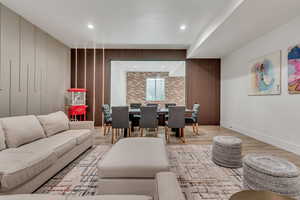 Living room featuring wood finished floors, recessed lighting, and wood walls