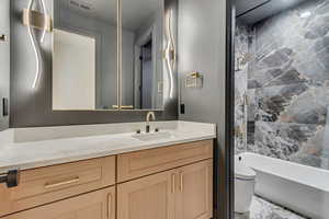 Full bath featuring vanity and  shower combination