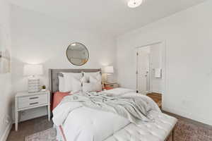 The main bedroom has gray carpet and an ensuite bath.