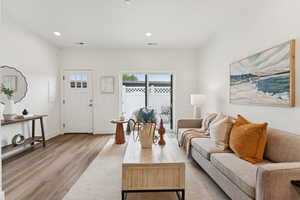 Living area featuring laminate (lvp) flooring and recessed lighting