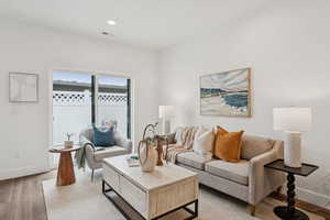 Living area featuring laminate (lvp) flooring and recessed lighting.