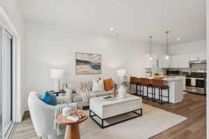 Living area featuring laminate (lvp) flooring and recessed lighting.