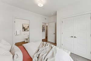 The main bedroom has gray carpet and an ensuite bath.