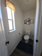 Bathroom with dark wood finished floors and baseboards