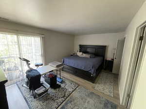 Bedroom featuring light wood-style flooring and access to exterior