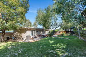 Back of property with a patio and brick siding
