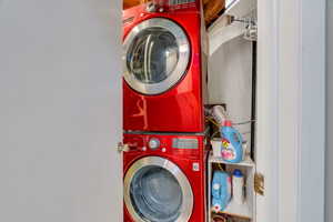 Laundry room featuring stacked washing machine and dryer