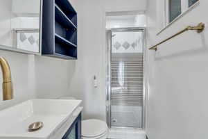 Bathroom featuring a shower stall, vanity, and tile patterned flooring
