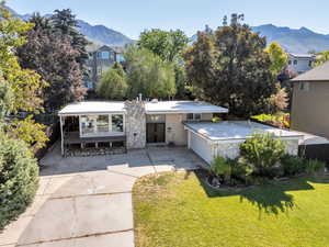 View of front of home featuring concrete driveway and a mountain view