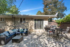 View of patio with an outdoor hangout area, outdoor dining space, and a grill