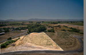 View of mountain backdrop with rural landscape