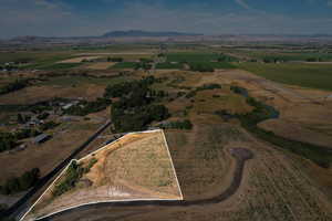 View of property location with a mountainous background, property boundaries highlighted, and rural landscape