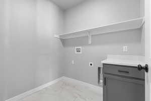 Washroom with light marble finish flooring, washer hookup, and electric dryer hookup
