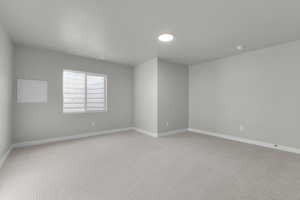 Unfurnished room featuring carpet flooring and baseboards