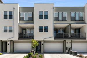 Contemporary house with concrete driveway and stucco siding