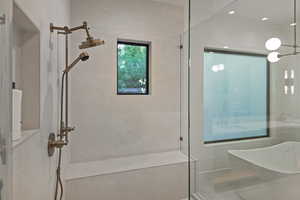 Full bathroom featuring a walk in shower and a freestanding tub