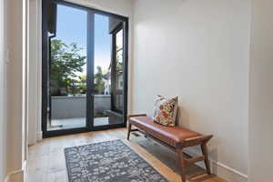 Doorway to outside with hardwood / wood-style flooring and baseboards