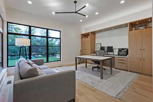 Office area with recessed lighting, light wood-style flooring, and a ceiling fan