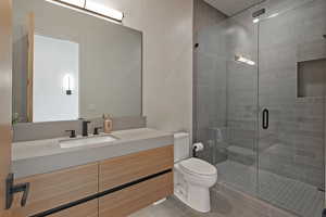 Bathroom with a stall shower, vanity, and light tile patterned floors