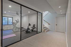 Workout room featuring recessed lighting, a ceiling fan, and light colored carpet