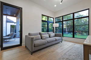 Living area featuring light wood-style flooring, recessed lighting, and plenty of natural light