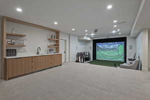 Home theater room featuring golf simulator, light carpet, and recessed lighting