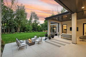 View of patio featuring an outdoor living space with a fire pit
