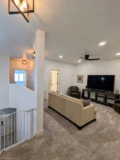 Carpeted living room featuring recessed lighting and ceiling fan