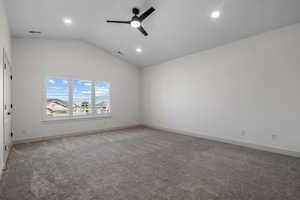 Unfurnished room featuring vaulted ceiling, light carpet, a ceiling fan, and recessed lighting