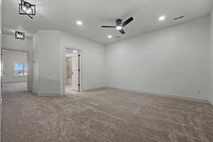Unfurnished room with light carpet, attic access, ceiling fan, and recessed lighting