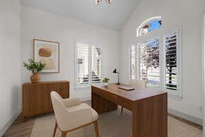 Office area featuring vaulted ceiling and light wood-type flooring