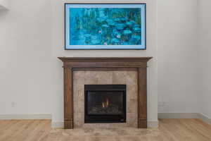 Detailed view of wood finished floors and a fireplace