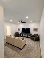 Living room featuring carpet flooring, recessed lighting, and ceiling fan