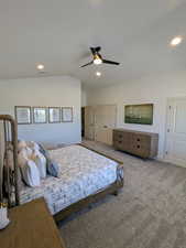 Bedroom with carpet flooring, vaulted ceiling, a ceiling fan, and recessed lighting