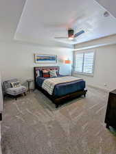 Bedroom with carpet flooring, a textured ceiling, and a ceiling fan
