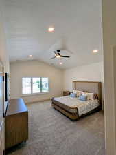Carpeted bedroom with vaulted ceiling, ceiling fan, and recessed lighting