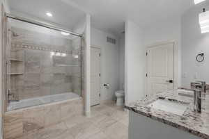 Full bathroom featuring tiled shower / bath combo, double vanity, and recessed lighting
