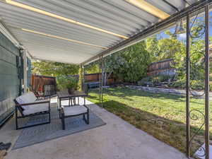 Fenced backyard with a patio and an outdoor living space