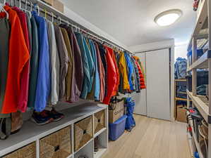 Walk in closet featuring light wood-style flooring